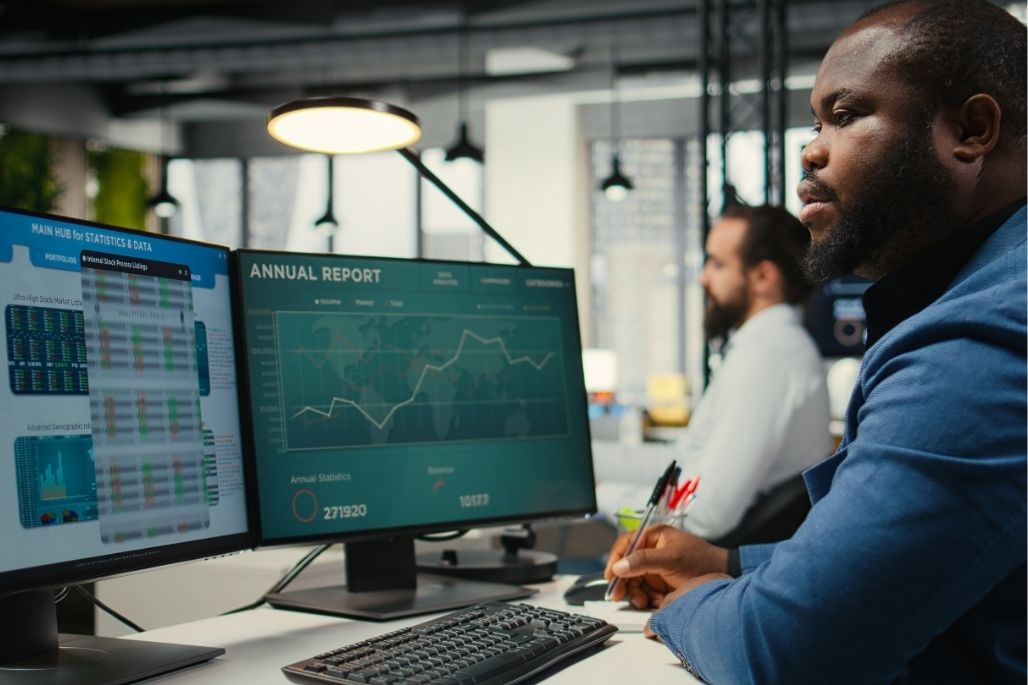 IT support professional working on a laptop in an office.