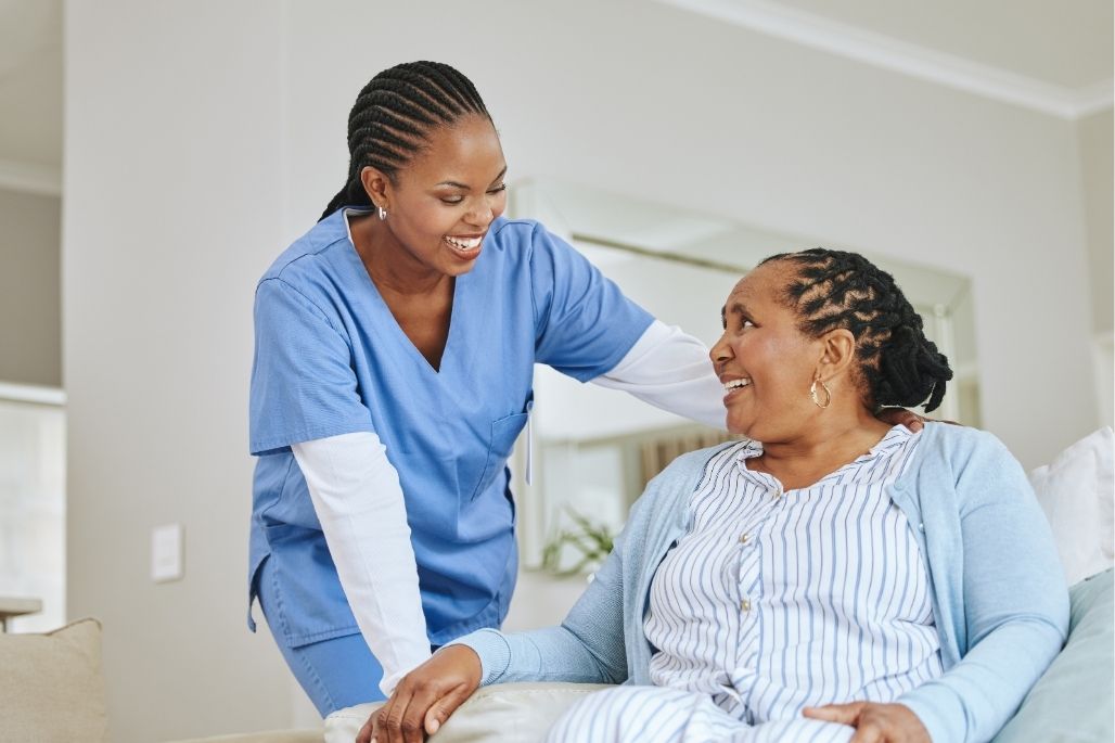 Medical assistant talking with a patient in a clinic.